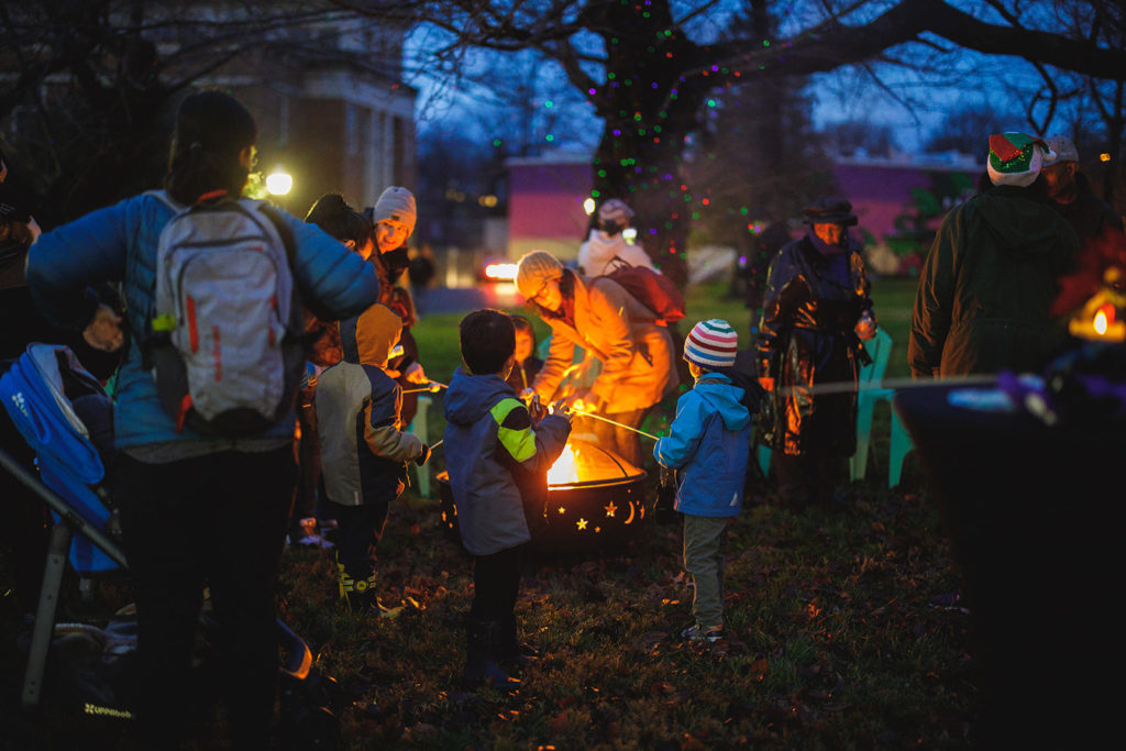 Families gather for smores making at a bonfire at The Parks.